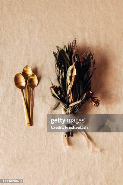 beautifully arranged golden spoons with dry leaf bouquet beside them (wedding decoration) - elegant spoon stock pictures, royalty-free photos & images