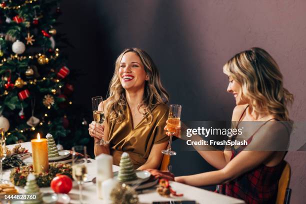 two happy beautiful blonde women enjoying christmas dinner - victory dinner stockfoto's en -beelden