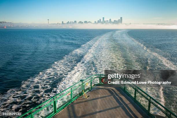 riding the seattle to bainbridge island ferryboat at sunrise. - seattle imagens e fotografias de stock