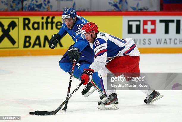 Thomas Larkin of Italy and Denis Kokarev of Russia battle for the puck during the IIHF World Championship group S match between Italy and Russia at...