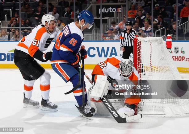 Felix Sandstrom of the Philadelphia Flyers gloves the puck during the second period against Oliver Wahlstrom of the New York Islanders at the UBS...