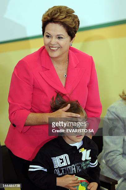 Brazil's President Dilma Rousseff hugs a child during the launching of Brasil Carinhoso program at the Planalto Palace in Brasilia, Brazil on May 14,...