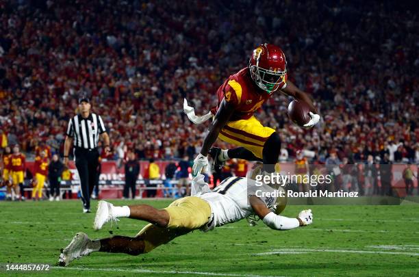 Mario Williams of the USC Trojans runs the ball against Jaden Mickey of the Notre Dame Fighting Irish in the second half at United Airlines Field at...