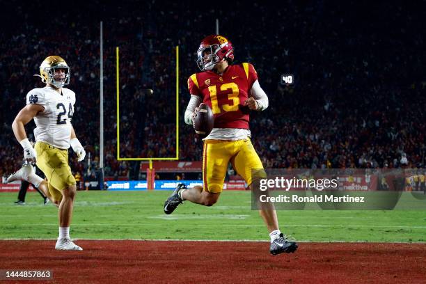 Caleb Williams of the USC Trojans runs for a touchdown against Jack Kiser of the Notre Dame Fighting Irish in the second half at United Airlines...