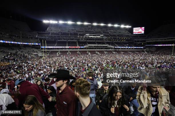 Fans rush the field following a Texas A&M Aggies win over LSU Tigers 38-23 during the second half at Kyle Field on November 26, 2022 in College...