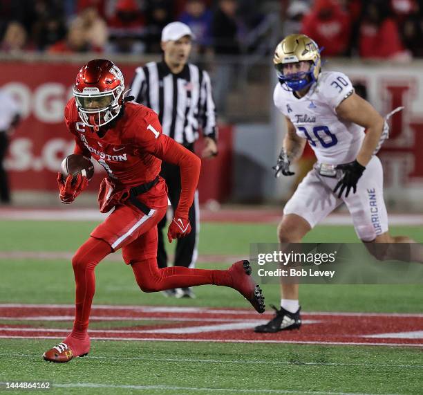 Nathaniel Dell of the Houston Cougars runs with the ball after a catch against the Tulsa Golden Hurricane during the second half at TDECU Stadium on...