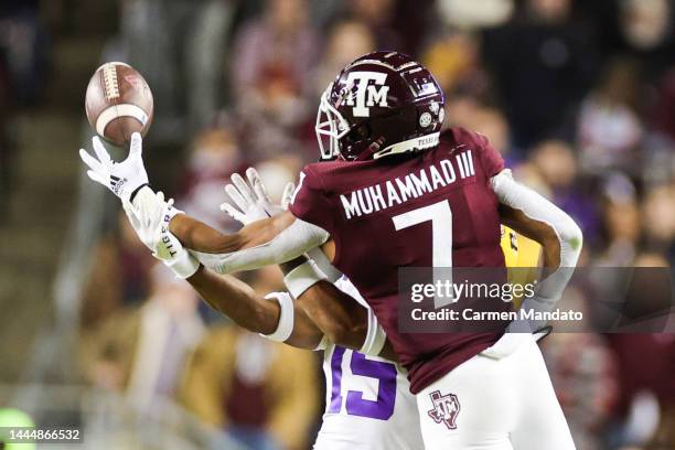 Moose Muhammad III of the Texas A&M Aggies makes a one handed catch ahead of Sage Ryan of the LSU Tigers during the second half at Kyle Field on...