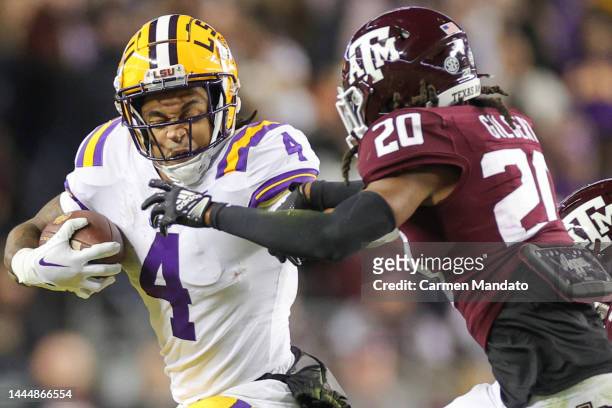 John Emery Jr. #4 of the LSU Tigers pushes off Jardin Gilbert of the Texas A&M Aggies during the first half at Kyle Field on November 26, 2022 in...