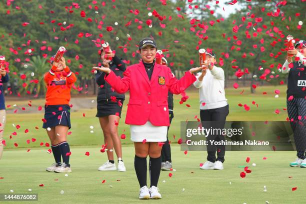Winner Miyuu Yamashita of Japan poses while follow golfers blow confetti at the award ceremony through the playoff following the final round of the...