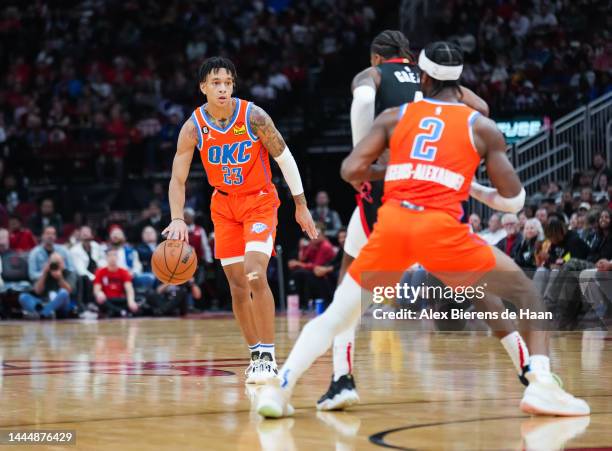 Tre Mann of the Oklahoma City Thunder dribbles the ball during the game against the Houston Rockets at Toyota Center on November 26, 2022 in Houston,...