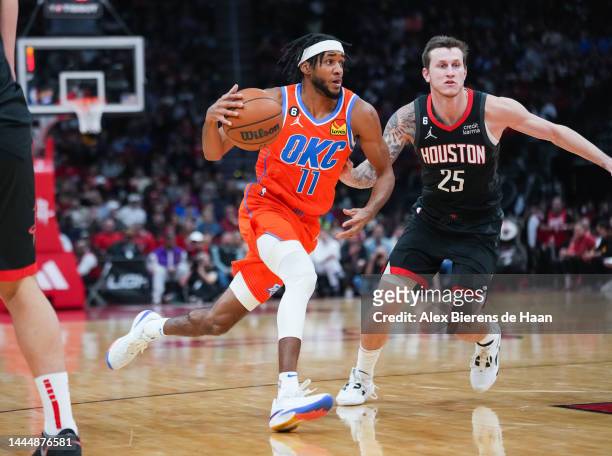 Isaiah Joe of the Oklahoma City Thunder dribbles the ball as Garrison Mathews of the Houston Rockets defends during the game at Toyota Center on...