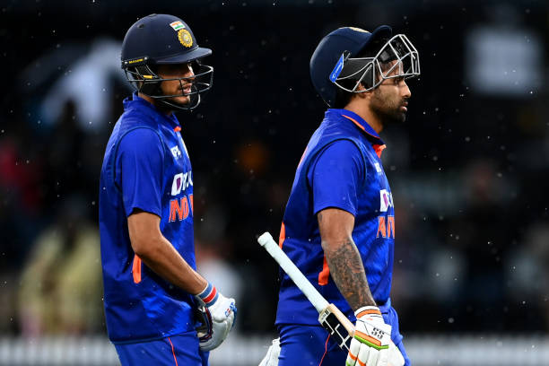 Shubman Gill and Suryakumar Yadav of India walk off after another rain delay during game two of the One Day International series between New Zealand...