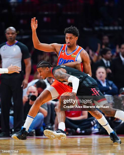 Jalen Green of the Houston Rockets dribbles the ball against Aaron Wiggins of the Oklahoma City Thunder during the game at Toyota Center on November...