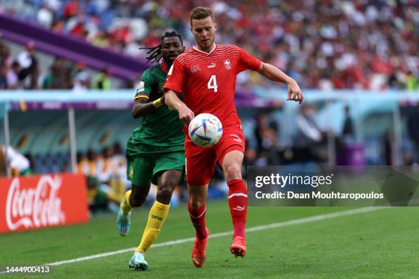 Nico Elvedi of Switzerland battles for the ball with Andre-Frank Zambo Anguissa of Cameroon during the FIFA World Cup Qatar 2022 Group G match...