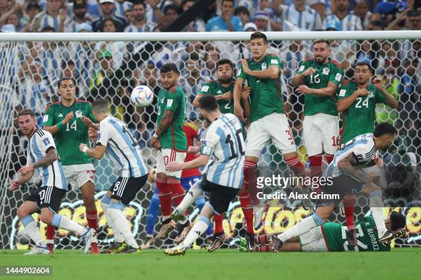 Lionel Messi of Argentina takes a free kick against Erick Gutierrez, Alexis Vega, Nestor Araujo, Cesar Montes, Hector Herrera and Luis Chavez of...