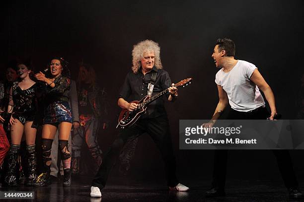 Queen musician Brian May performs with cast member Noel Sullivan during the We Will Rock You 10 Year Anniversary Celebration performance at The...
