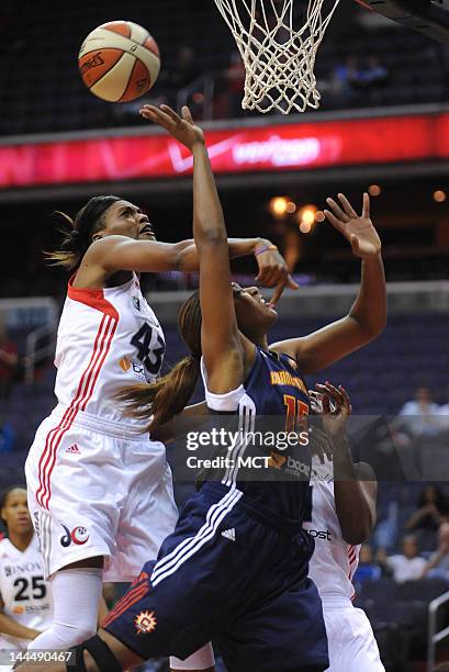 Connecticut Sun forward Asjha Jones gets fouled by Washington Mystics guard Dominique Canty , right, as she drives to the basket against Mystics...