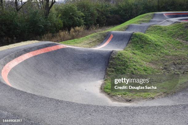 view of an asphalt pumptrack in a park. - bmx park stock pictures, royalty-free photos & images