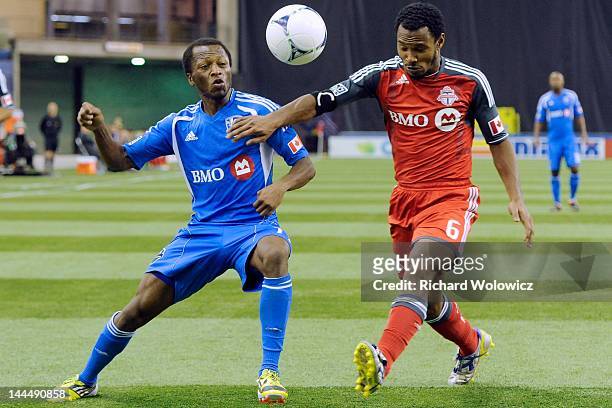 Sanna Nyassi of the Montreal Impact and Julian de Guzman of the Toronto FC battle for the ball during the MLS match at the Olympic Stadium on April...