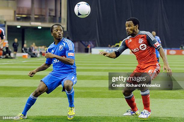 Sanna Nyassi of the Montreal Impact and Julian de Guzman of the Toronto FC battle for the ball during the MLS match at the Olympic Stadium on April...