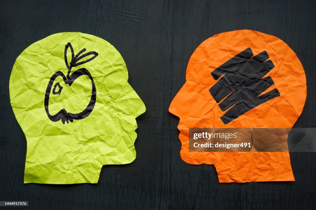 Two heads from paper and one with apple. Aphantasia concept.
