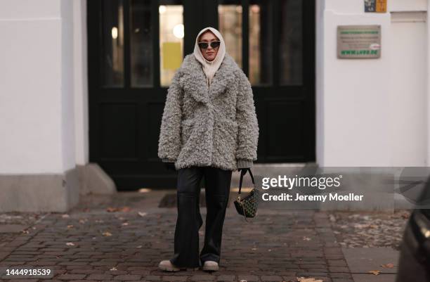 Sonia Lyson is seen wearing Gucci black leather gloves, Prada triangle green bag, Copenhagen Studios beige boots, Edited black leather wide leg...