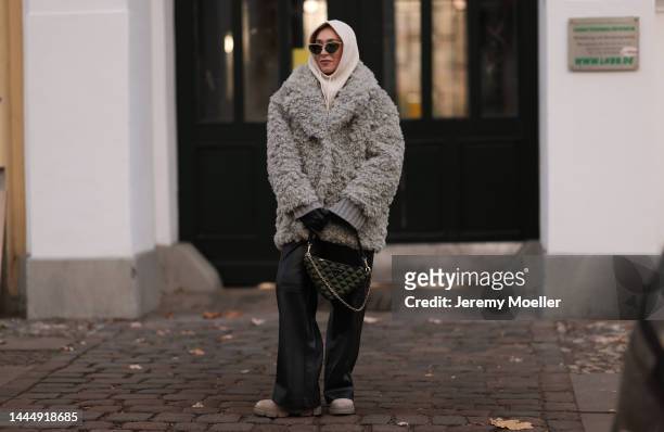 Sonia Lyson is seen wearing Gucci black leather gloves, Prada triangle green bag, Copenhagen Studios beige boots, Edited black leather wide leg...