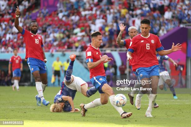 Junya Ito of Japan is fouled by Francisco Calvo of Costa Rica during the FIFA World Cup Qatar 2022 Group E match between Japan and Costa Rica at...