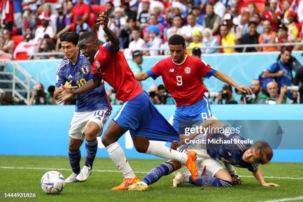 Joel Campbell of Costa Rica controls the ball against Takumi Minamino and Kou Itakura of Japan during the FIFA World Cup Qatar 2022 Group E match...