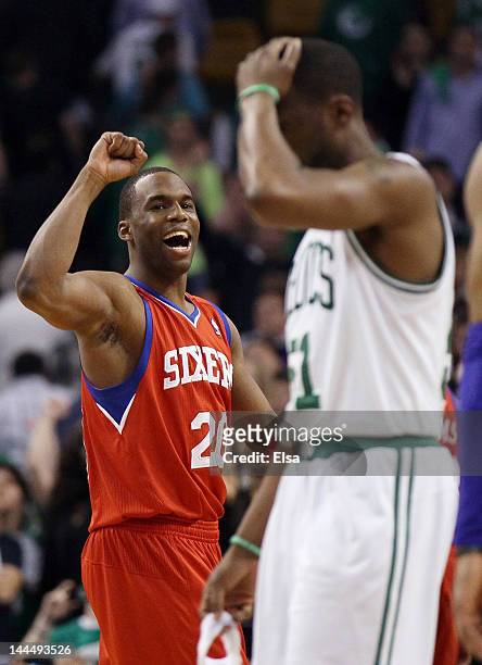 Jodie Meeks of the Philadelphia 76ers celebrates the win as Keyon Dooling of the Boston Celtics walks off the court after Game Two of the Eastern...