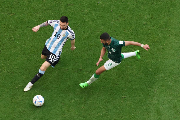 Lionel Messi of Argentina is challenged by Abdulelah Almalki of Saudi Arabia during the FIFA World Cup Qatar 2022 Group C match between Argentina and...