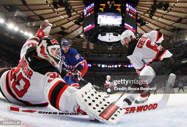 Martin Brodeur and Andy Greene of the New Jersey Devils defend against the New York Rangers in Game One of the Eastern Conference Final during the...