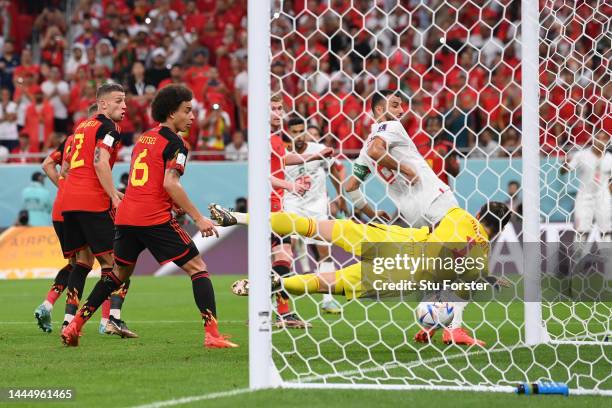 Thibaut Courtois of Belgium dives in vain as Abdelhamid Sabiri of Morocco scores their team's first goal from a free kick during the FIFA World Cup...