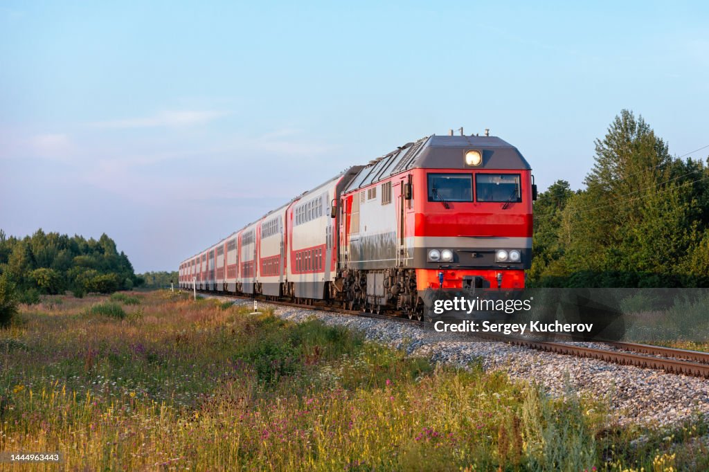Powerful diesel locomotive with double-decker passenger train