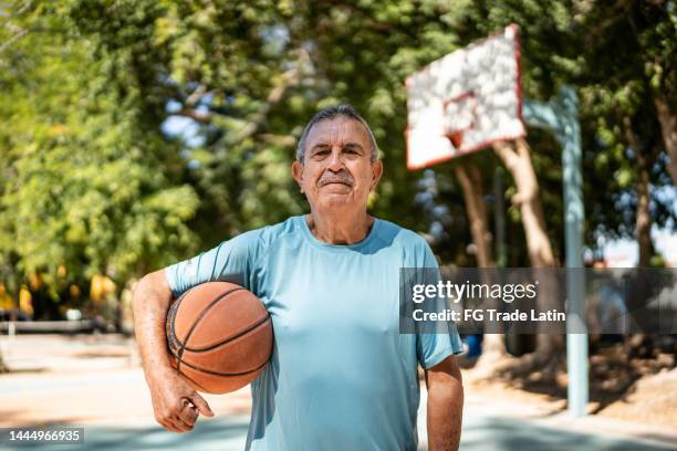 portrait of senior man at the basketball court - old basketball hoop stock pictures, royalty-free photos & images