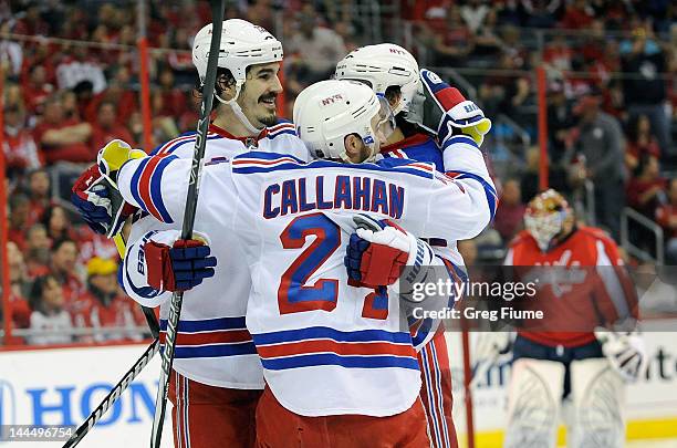 Artem Anisimov of the New York Rangers celebrates with Ryan Callahan and Brian Boyle after scoring in the second period against the Washington...