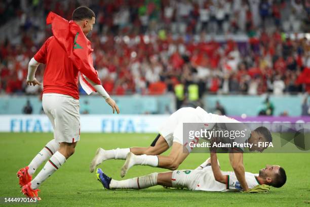 Bilal El Khannouss , Achraf Hakimi and Hakim Ziyech of Morocco celebrate their 2-0 victory in the FIFA World Cup Qatar 2022 Group F match between...
