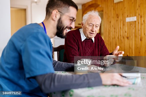 Caretaker with senior man enjoying coffee break Caretaker with senior man enjoying coffee break