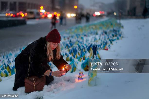 Members of the public are seen lighting candles in Independence square on November 27, 2022 in Kyiv, Ukraine. In recent days, Russia has retreated...