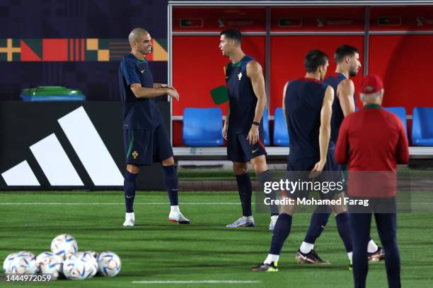 Cristiano Ronaldo of Portugal interacts with teammate Pepe during the Portugal Training Session on match day -1 at Al Shahaniya Sports Club on...