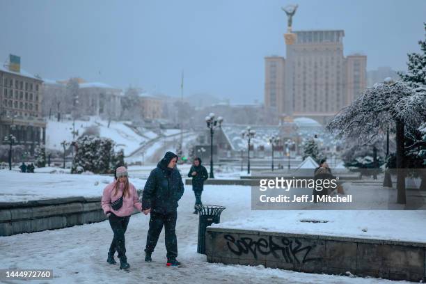 Members of the public are seen making their way through the snow Independence square on November 27, 2022 in Kyiv, Ukraine. In recent days, Russia...