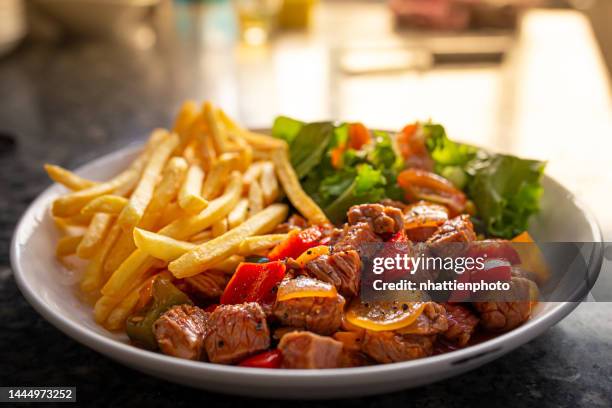 french fries with shaky beef, vegetables served on a white plate high resolution stock photo - shaky stock pictures, royalty-free photos & images