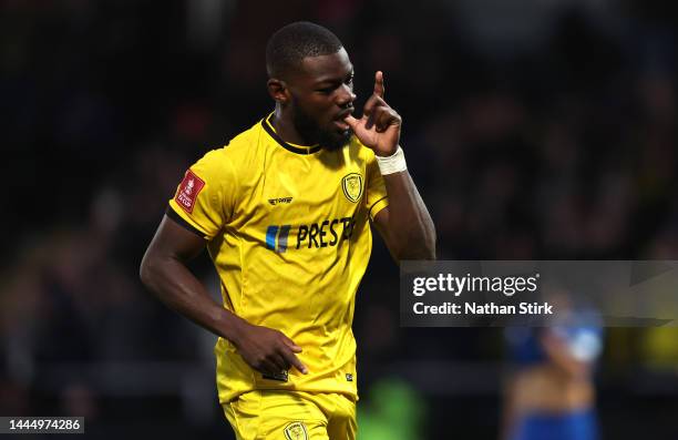 Adedeji Oshilaja of Burton Albion celebrates after he scores their sixth goal during the Emirates FA Cup Second Round match between Burton Albion and...