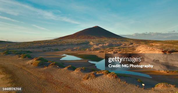 aerial view of montaña roja and sea lagoon during sunrise at el medano, tenerife canary islands - volcanic landscape stockfoto's en -beelden