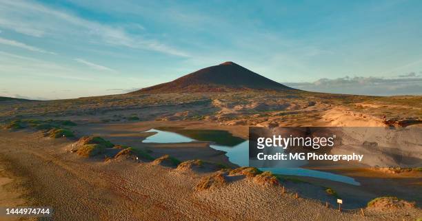 aerial view of montaña roja and sea lagoon during sunrise at el medano, tenerife canary islands - tenerife stock pictures, royalty-free photos & images
