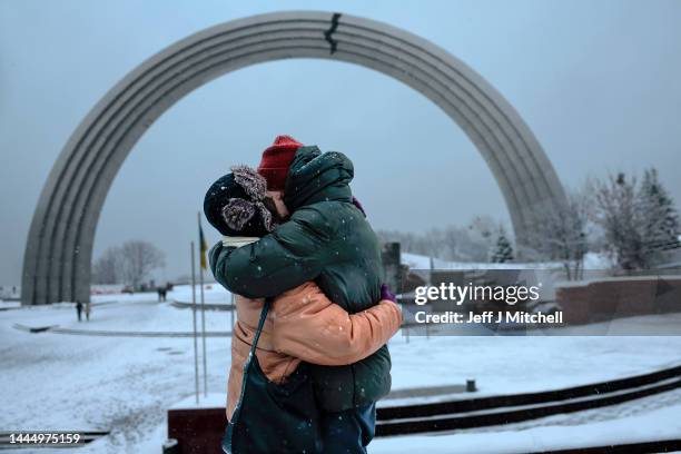 Couple embrace in the snow at The Arch of Freedom of the Ukrainian people on November 27, 2022 in Kyiv, Ukraine. In recent days, Russia has retreated...