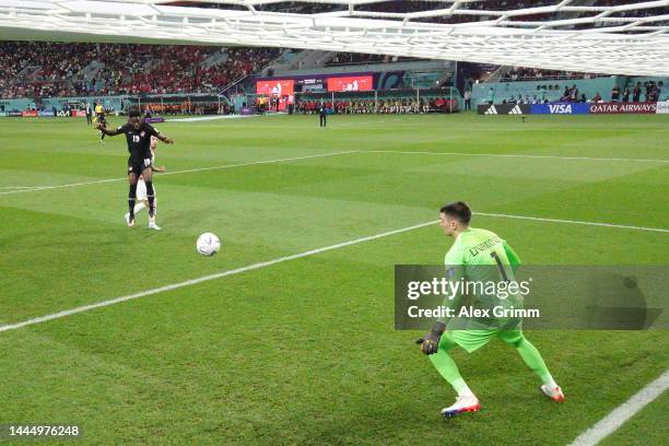 Alphonso Davies of Canada scores their team's first goal past Dominik Livakovic of Croatia during the FIFA World Cup Qatar 2022 Group F match between...