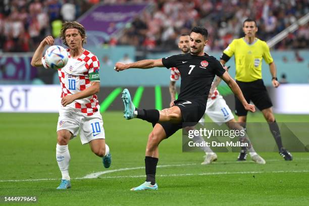 Stephen Eustaquio of Canada clears the ball in front of Luka Modric of Croatia during the FIFA World Cup Qatar 2022 Group F match between Croatia and...