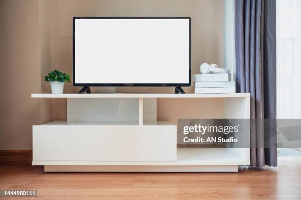 smart tv on the cabinet in modern living room on white wall background. modern white shelf with flat tv at home - smart tv stock pictures, royalty-free photos & images