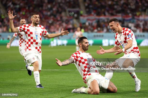 Marko Livaja of Croatia celebrates with teammates Mateo Kovacic and Ivan Perisic after scoring their team's second goal during the FIFA World Cup...
